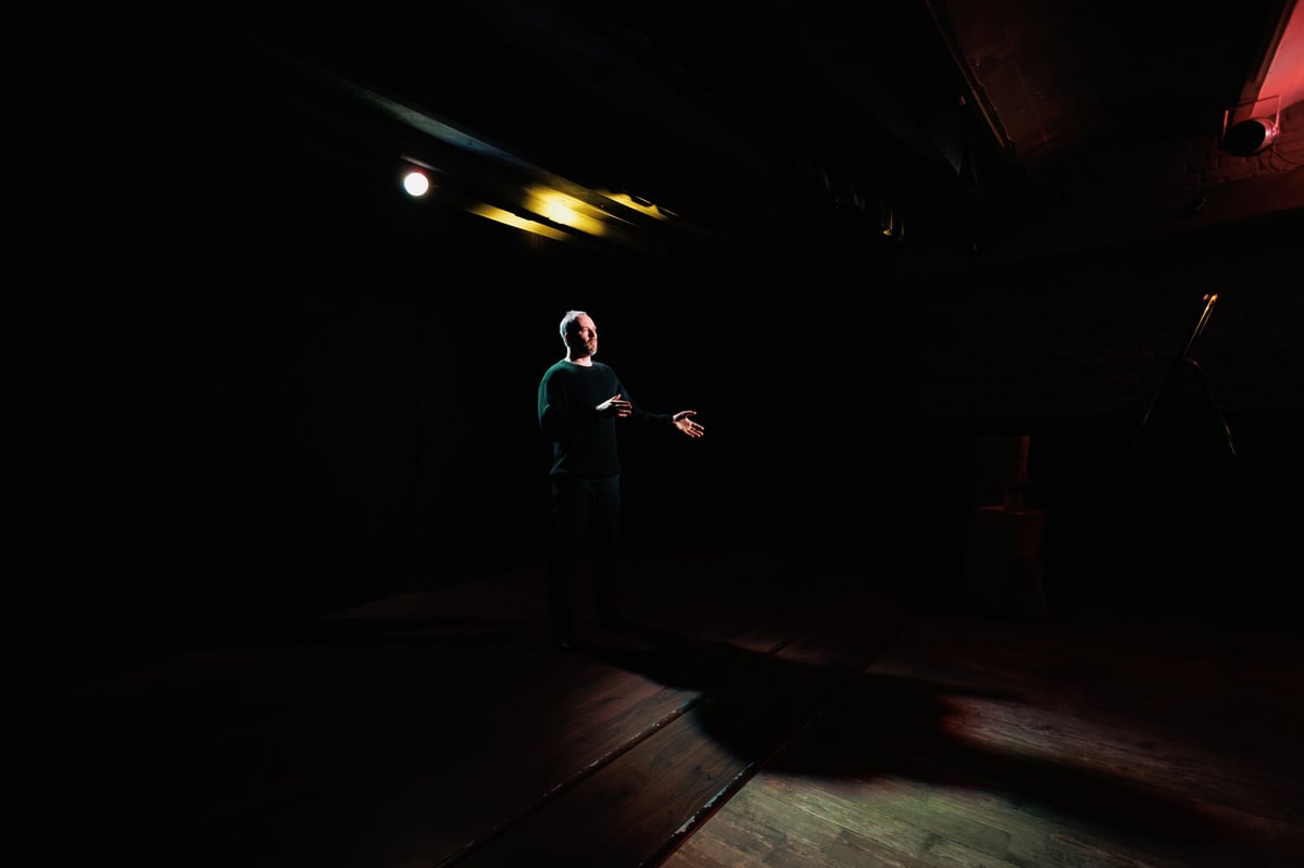 Adult actor acting in theater with lights