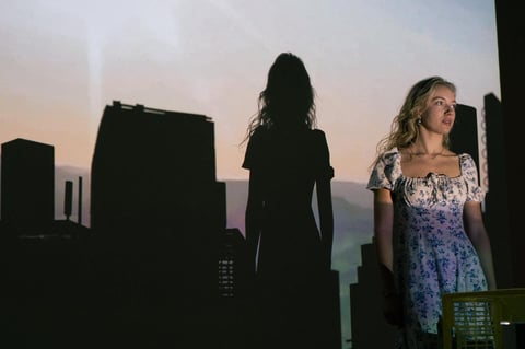 Zwei Frauen silhouettenhaft vor einer Stadt skyline bei Dämmerung